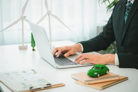 Businessman working in office developing plan on ev car. Gyre Stock Photos