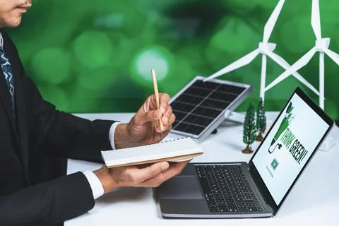 Businessman working in office developing plan on alternative energy. Gyre Stock Photos