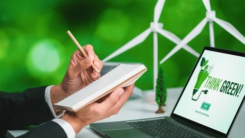 Businessman working in office developing plan on alternative energy. Gyre Stock Photos