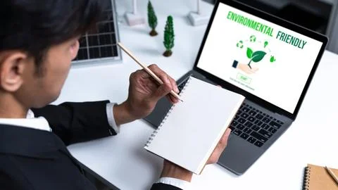 Businessman working in office developing plan on alternative energy. Gyre Stock Photos