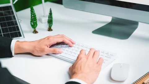 Businessman working in office developing plan on alternative energy. Gyre Stock Photos
