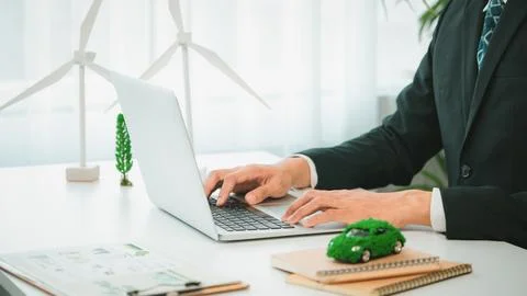 Businessman working in office developing plan on ev car. Gyre Stock Photos