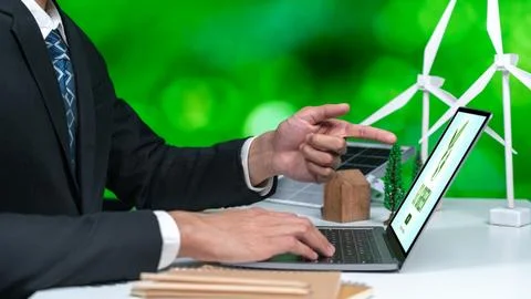 Businessman working in office developing plan on alternative energy. Gyre Stock Photos