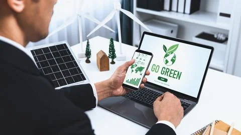 Businessman working in office developing plan on alternative energy. Gyre Stock Photos