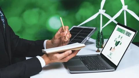 Businessman working in office developing plan on alternative energy. Gyre Stock Photos