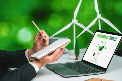 Businessman working in office developing plan on alternative energy. Gyre Stock Photos