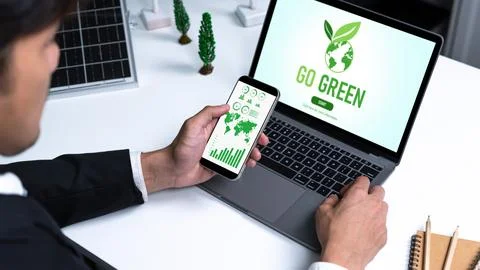 Businessman working in office developing plan on alternative energy. Gyre Stock Photos