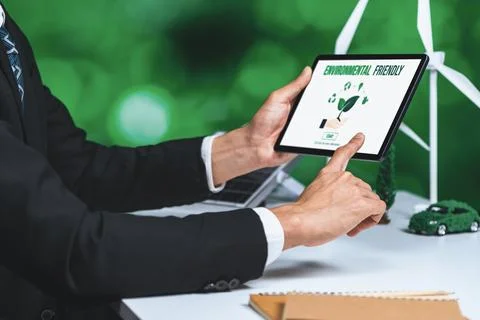 Businessman working in office developing plan on alternative energy. Gyre Stock Photos