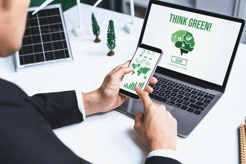 Businessman working in office developing plan on alternative energy. Gyre Stock Photos