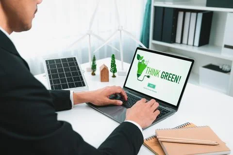 Businessman working in office developing plan on alternative energy. Gyre Stock Photos