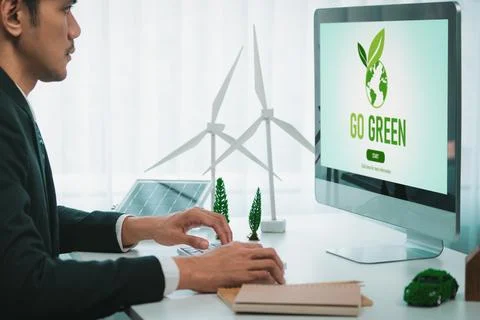 Businessman working in office developing plan on alternative energy. Gyre Stock Photos