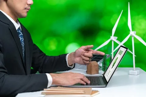 Businessman working in office developing plan on alternative energy. Gyre Stock Photos