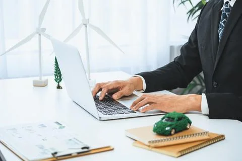 Businessman working in office developing plan on ev car. Gyre Stock Photos