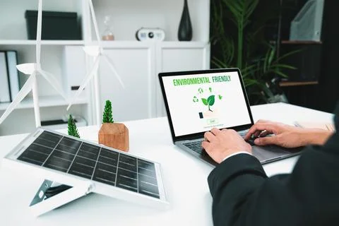 Businessman working in office developing plan on alternative energy. Gyre Stock Photos