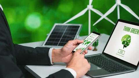 Businessman working in office developing plan on alternative energy. Gyre Stock Photos