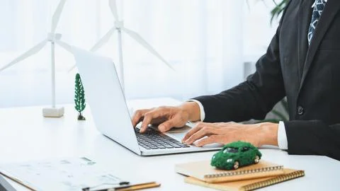 Businessman working in office developing plan on ev car. Gyre Stock Photos
