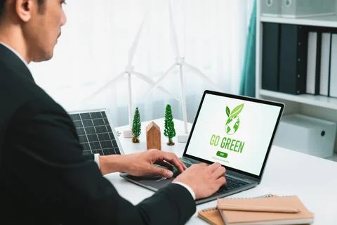 Businessman working in office developing plan on alternative energy. Gyre Stock Photos