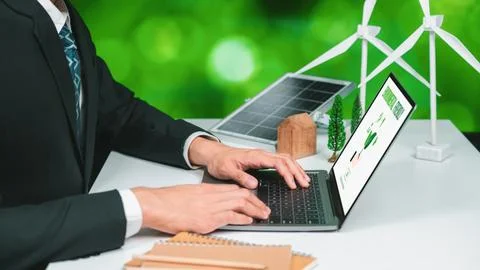 Businessman working in office developing plan on alternative energy. Gyre Stock Photos