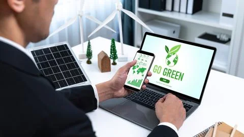 Businessman working in office developing plan on alternative energy. Gyre Stock Photos