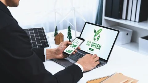 Businessman working in office developing plan on alternative energy. Gyre Stock Photos