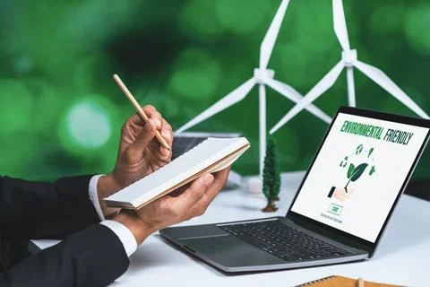Businessman working in office developing plan on alternative energy. Gyre Stock Photos