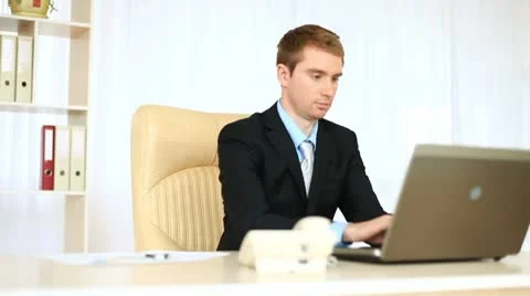 Businessman working in office looking at camera. DOLLY HD 動画素材 8954507
