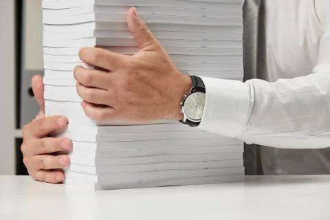 Businessman working at an office, reads stack of books and reports. Business  Stock Photos