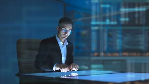 The businessman working with a sensor display on the hologram background Stock-Footage 100577647