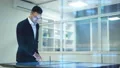 The businessman working with a sensor screen on the hologram background 4k or 4k+ Resolution