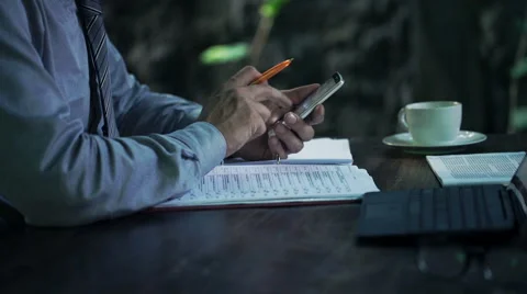 Businessman working with smartphone and documents by table at home HD 스톡 동영상 54900326