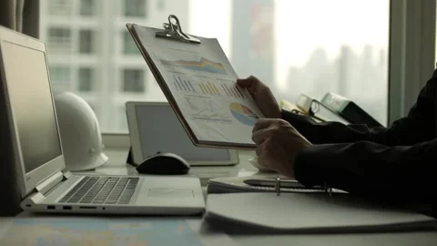 Businessman working on some pie charts in his office Stock Footage 239019891