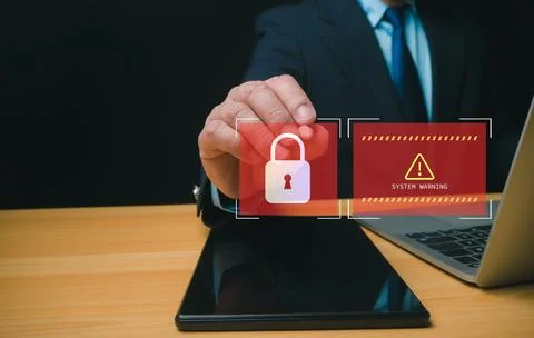 Businessman working on tablet and computer online showing protection icons .. Stock Photos