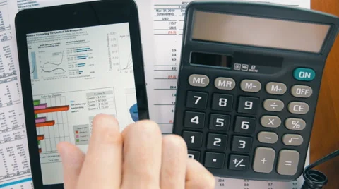 Businessman working on the tablet, calculating data and calling by phone Stock Footage 55259760