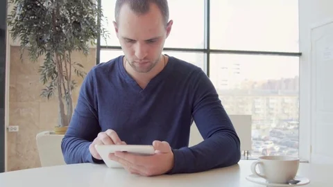 Businessman working on tablet computer and drinking coffee in cafe 스톡 동영상 73363909