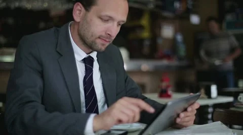 Businessman working on tablet computer in the cafe, steadicam shot HD Stock Footage 11098988
