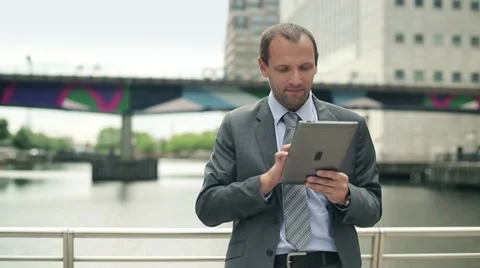 Businessman working on tablet computer in the city HD Stock Footage 11498207