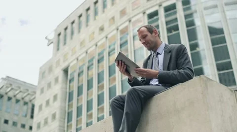 Businessman working on tablet computer in the city HD Stock Footage 11498213