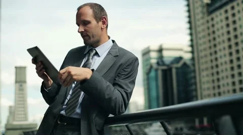 Businessman working on tablet computer in the city HD Stock Footage 11513900