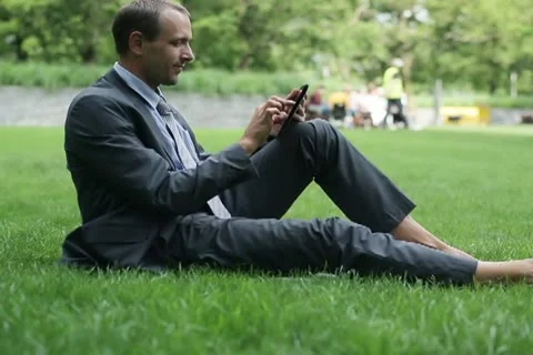 Businessman working on tablet computer in the park NTSC 스톡 동영상 11514211