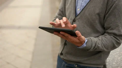 Businessman working on tablet computer by the street, 1080p Stock Footage 28505155