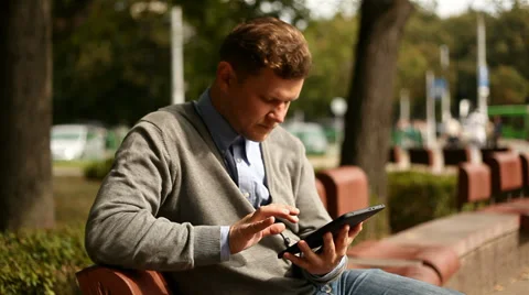 Businessman working on tablet computer by the street, 1080p Stock Footage 28505188