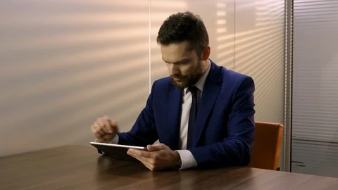 Businessman working on a tablet in a modern office. Stock Footage 101970233