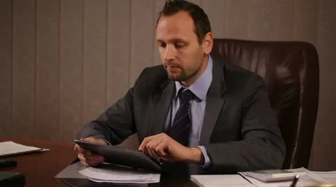 Businessman working with the tablet in the office Stock Footage 10956169