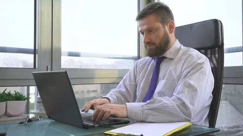 Businessman working, writing on laptop computer in office Vídeo Stock 73169149