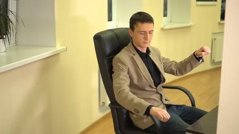 Businessman at the workplace dreams about how he drives the car he toggles the Stock Footage