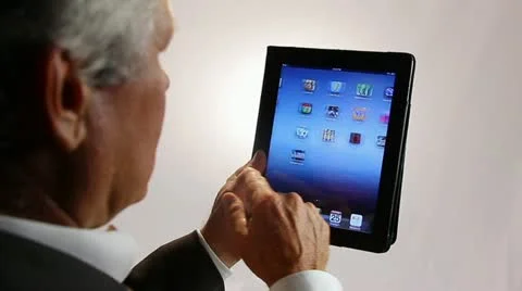 BUSINESSMAN WORKS WITH APPS ON A TABLET COMPUTER Stock Footage 12155044