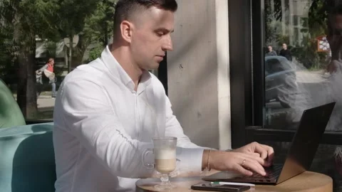 Businessman works on computer outside from office Stock Footage 220568248