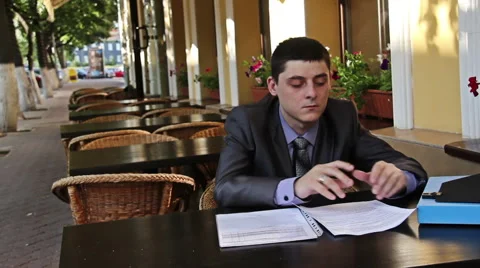 Businessman works with documents in the cafe Stock Footage 40309530