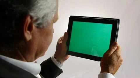 BUSINESSMAN WORKS ON A GREENSCREEN TABLET COMPUTER 3 Stock Footage 12159482