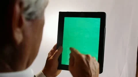 BUSINESSMAN WORKS ON A GREENSCREEN TABLET COMPUTER 2 Stock Footage 12159684